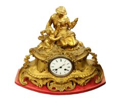 A 19th century gilt metal ornate mantel clock, having mother and child figural display upon