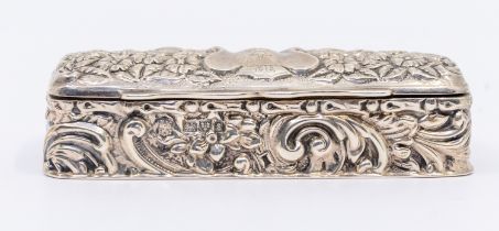 An Edwardian silver snuff box, of oblong rectangular form with elaborate floral and foliage embossed