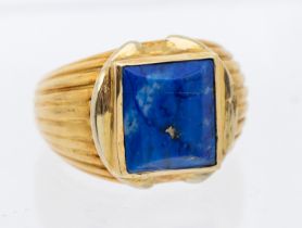 A French vintage lapis lazuli and gold ing, comprising a rub over set faceted rectangular cut