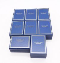 A collection of eight boxed Halcyon Days enamelled boxes to include; Happy Anniversary 2003, Who