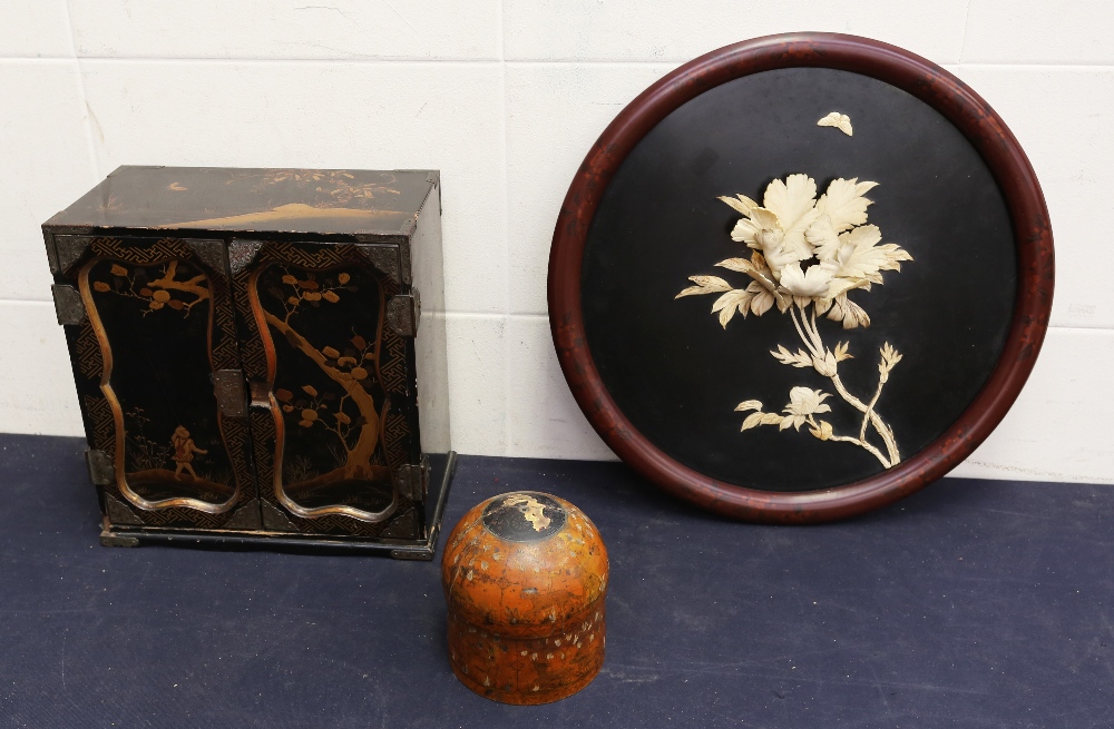 An early 20th Century Chinese black lacquered small table top cabinet, Chinese round wall hanging,