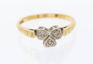 A diamond and 18ct gold set ring, comprising a platinum clower motif set with small diamonds, size