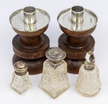 A pair of George V silver topped oak candle sticks of abstract stylised design, hallmarked by FJ