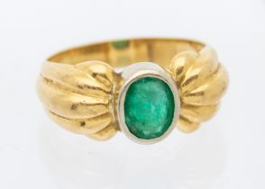 A French emerald and 18ct gold retro ring, comprising a bow like mount, set to the centre with an
