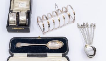 A small collection of silver to include; a Queen Elizabeth II six bar toast rack, hallmarked by