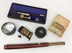 Mid 20th Century cased instruments, ivory bakalite cased weights, scientific lenses and telescope.