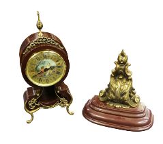 A 20th century or modern Lafuente mantel clock, ornate style with brass detailing and curled legs,