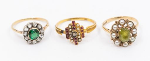 A collection of stone set gold rings to include a diamond and green garnet cluster ring set with a
