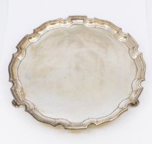 A George VI silver salver, with piecrust border and on three scrolled feet, hallmarked by CJ