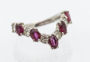 A ruby and diamond 18ct white gold wish bone half eternity ring, comprising alternative oval mixed