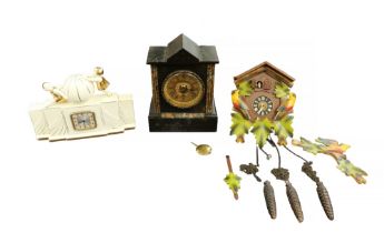 A 20th Century cuckoo clock, a 1930s ceramic mantel clock and an early 20th Century mantel clock.