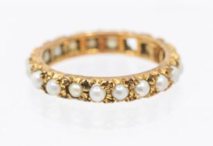 A pear set 9ct gold eternity ring, set with half pearls, width approx 3mm, size M1/2, (one pearl