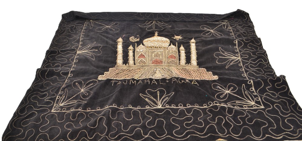 A black cloth depicting the Taj Mahal in rich gold bead encrusted embroidery stitched onto black