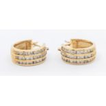 A pair of diamond and gold set creole hoops, comprising three rows of channel set round brilliant
