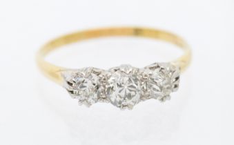 A diamond three stone 18ct gold ring, comprising three round brilliant cut diamonds graduating in