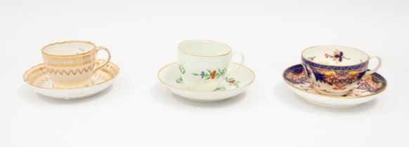 A late 18th Century English fluted tea cup and saucer, decorated with monogram ‘A’, below a gilt