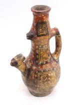 A South American hand decorated single handled vessel, probably pre-Colombian