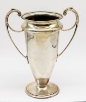 An Edwardian silver twin handled trophy vase, circular footed base, of stylised form, hallmarked