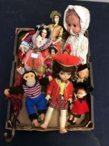 A collection of tourist dolls, clock work monkey and other collectable dolls.