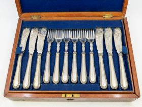 A mid 20th Century canteen of silver plated fish knives and forks in mahogany box.