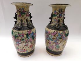 Large pair of early 20th century Japanese satsuma vases with crackle glaze and battle detail. Both