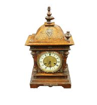 An early 20th century Junghans wooden cased bracket clock, with carved detail, metal mounted areas