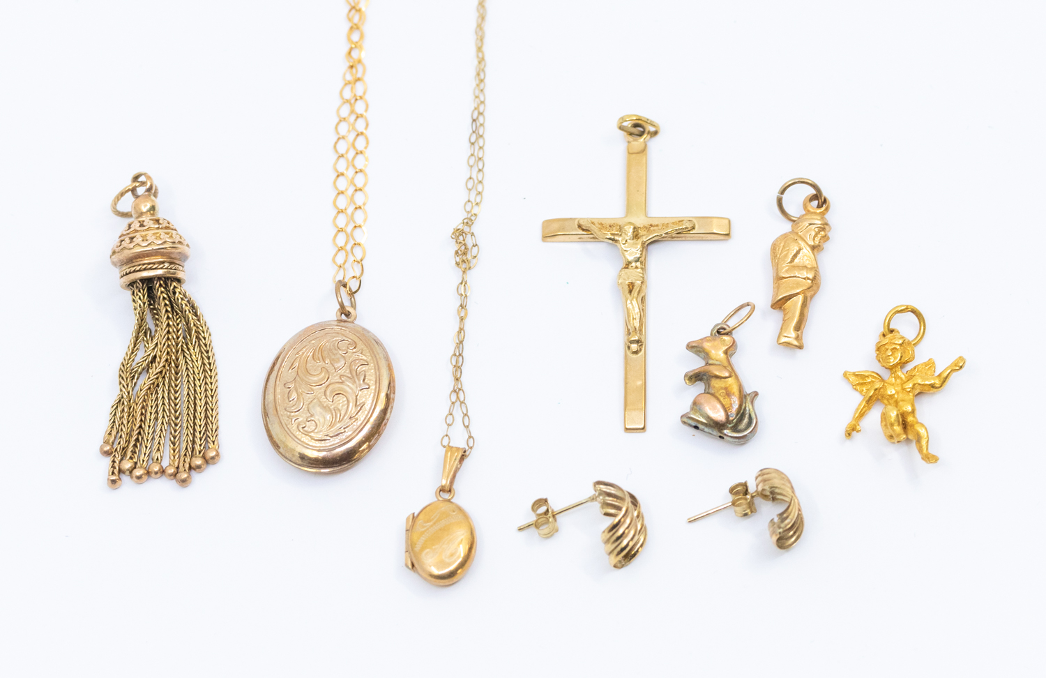 A collection of 9ct gold jewellery including a  tassel fob, cross, small oval locket and chain,