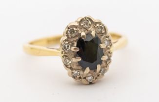 A sapphire and diamond 18ct gold oval cluster ring, setting size approx 8 x 11mm, size N, total