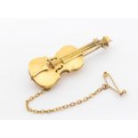 A 9ct gold brooch in the form of a violin, length approx 43mm, C clasp, with later metal pin,