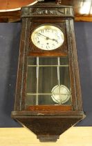 A 1920s/30s oak cased wall clock, 8 day with Arabic numerals and bevelled glazed pendulum window.