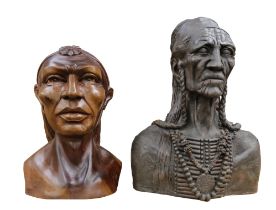 A resin bust of a native American along with a wooden bust of a native American.