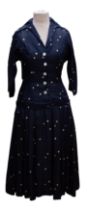 A 1956 silk dress by Cohen & Goshin New York in midnight/navy blue with cream spots in the New Look