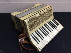 A 20th century Hohner faux mother of pearl cased accordian.