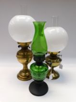 Three 20th century or later oil lamps to include: 2 brass with white shades and clear glass funnels,