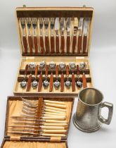 A mid 20th Century steel and wooden handled cased knife, fork and spoon set, marked Sheffield