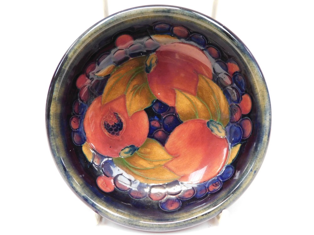 1920's William Moorcroft blue ground bowl in the pomegranate pattern, chip to foot rim