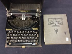 A cased black Remmington vintage typewriter along with a typewriter manual.