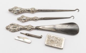 A collection of mixed silver items to include; two Birmingham silver handled button/shoe hooks, both