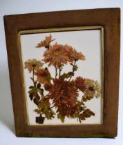 A late 19th Century wall hanging frame with original green fabric cover surrounding floral still