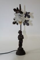 A simulated bronze figural table lamp, with frosted petal shade. Total height, 49cm