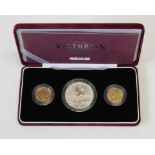 A cased Victorian Centenary Collection of three coins, a five pound coin, a 2001 sovereign and a