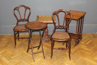 A nesting set of three satinwood occasional tables, a pair of crown back cane seat bedroom chairs, a