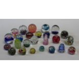 A collection of twenty five 20th century paperweights. Various, including floral, scrambled and