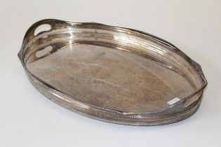 A silver plated oval tray of large size, having an undulated pierced raised side, width 62cm