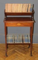 An Edwardian mahogany and pataral inlaid occasional bookcase, the upper shelf over a frieze drawer