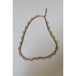 A 9ct gold embossed swag form necklace, with 375 stamped extender chain. Approximate length 40 cm