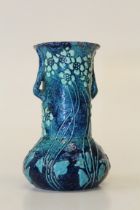 An Art Nouveau blue glazed small pottery vase probably by C J Brannam, decorated with glazed