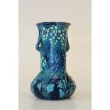 An Art Nouveau blue glazed small pottery vase probably by C J Brannam, decorated with glazed