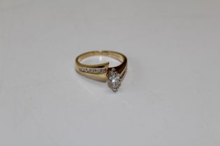 A diamond marquise solitaire ring, the principal stone an estimated 0.40 carats. Set on a yellow
