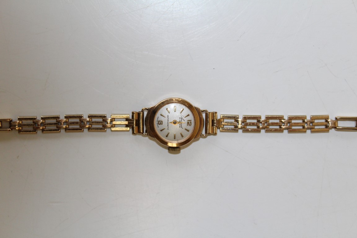 A 9ct yellow gold cased Accurist ladies cocktail watch on a 1/10 12ct rolled gold bracelet. At fault